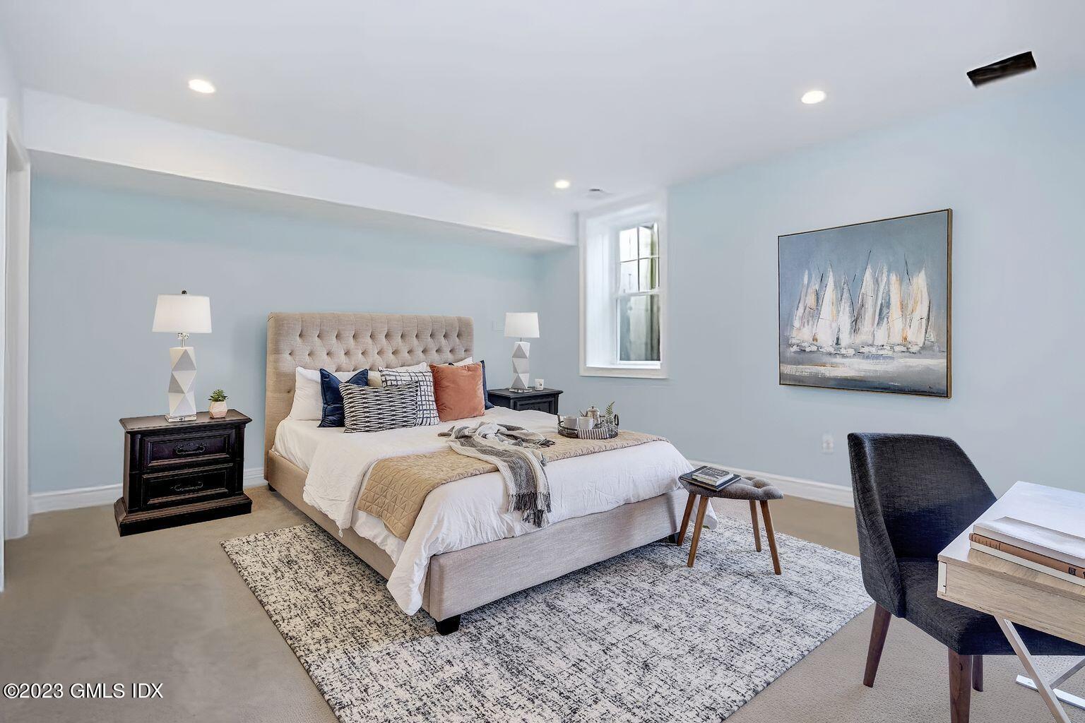 196 Valley Road Cos Cob, CT 06807 - Photo 15 of 18 a bed room with a bed a chair and a potted plant