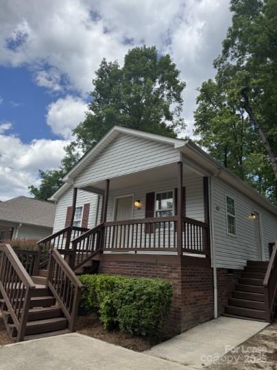 a view of a house with large windows and a small yard