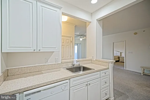 a kitchen with sink cabinets and a window