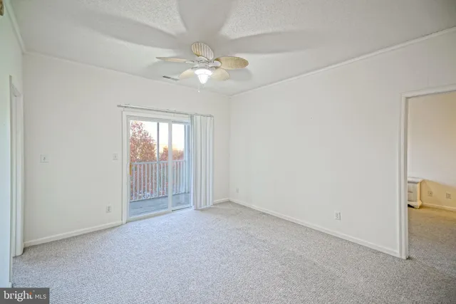 an empty room with chandelier fan