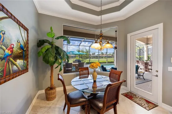 a dining room filled with furniture and chandelier