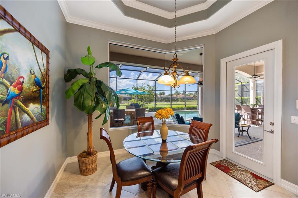 8902 Shenendoah Circle Naples, FL 34113 - Photo 11 of 28 a dining room filled with furniture and chandelier
