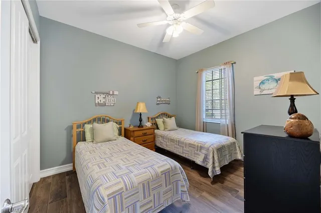 a bedroom with two beds and a lamp