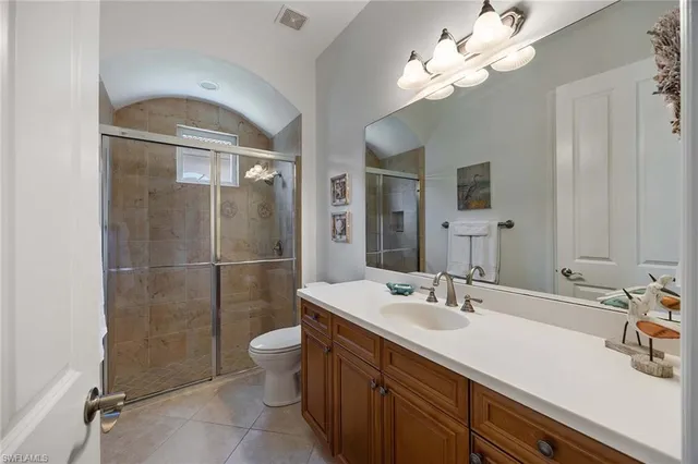 a bathroom with a sink a toilet and a shower