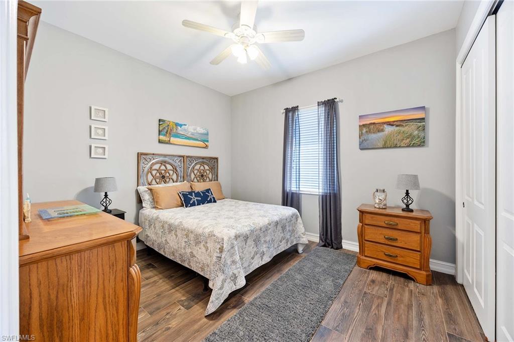 8902 Shenendoah Circle Naples, FL 34113 - Photo 19 of 28 a bedroom with a bed and a dresser in it