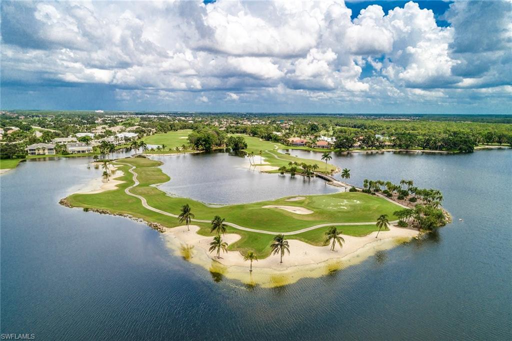 8902 Shenendoah Circle Naples, FL 34113 - Photo 25 of 28 a view of a lake with a house in the background
