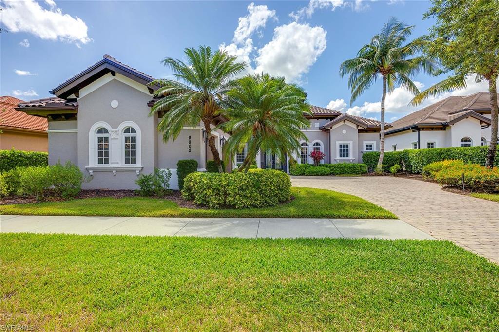 8902 Shenendoah Circle Naples, FL 34113 - Photo 3 of 28 a front view of a house with a garden