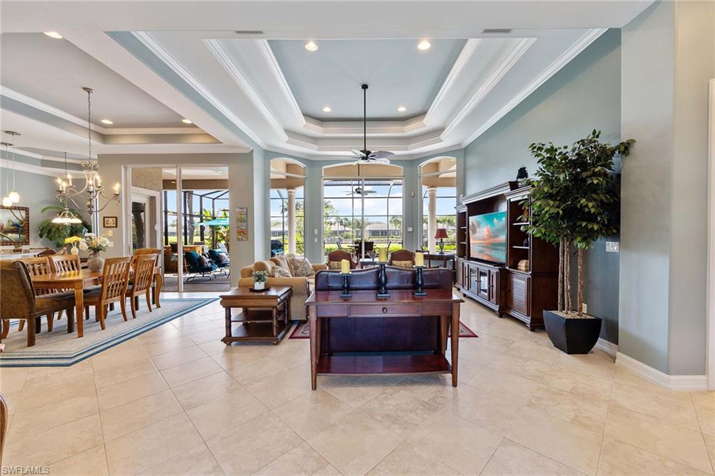 8902 Shenendoah Circle Naples, FL 34113 - Photo 4 of 28 a living room with furniture a chandelier and a large window