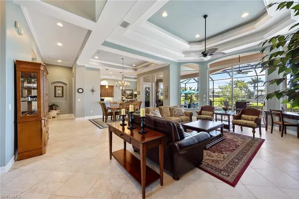 a living room with furniture and a chandelier