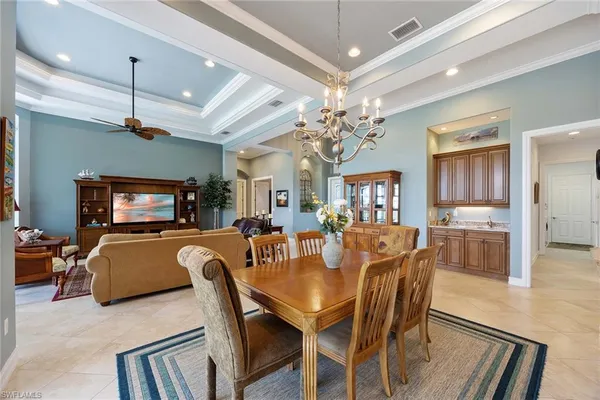 a view of a dining room with furniture wooden floor and chandelier