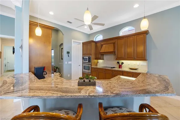 a kitchen with granite countertop wooden cabinets and granite counter tops