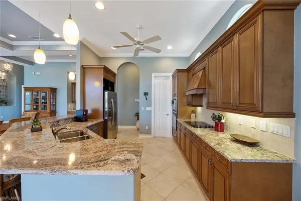 a kitchen with stainless steel appliances granite countertop a sink and cabinets