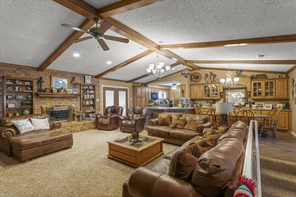 a living room with furniture and a ceiling fan