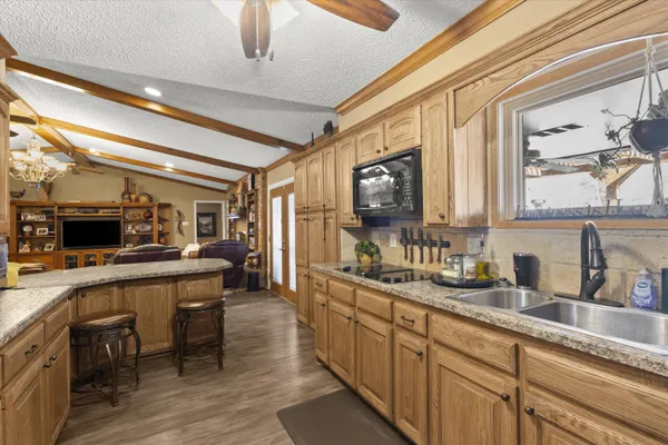 a kitchen with lots of counter top space and appliances