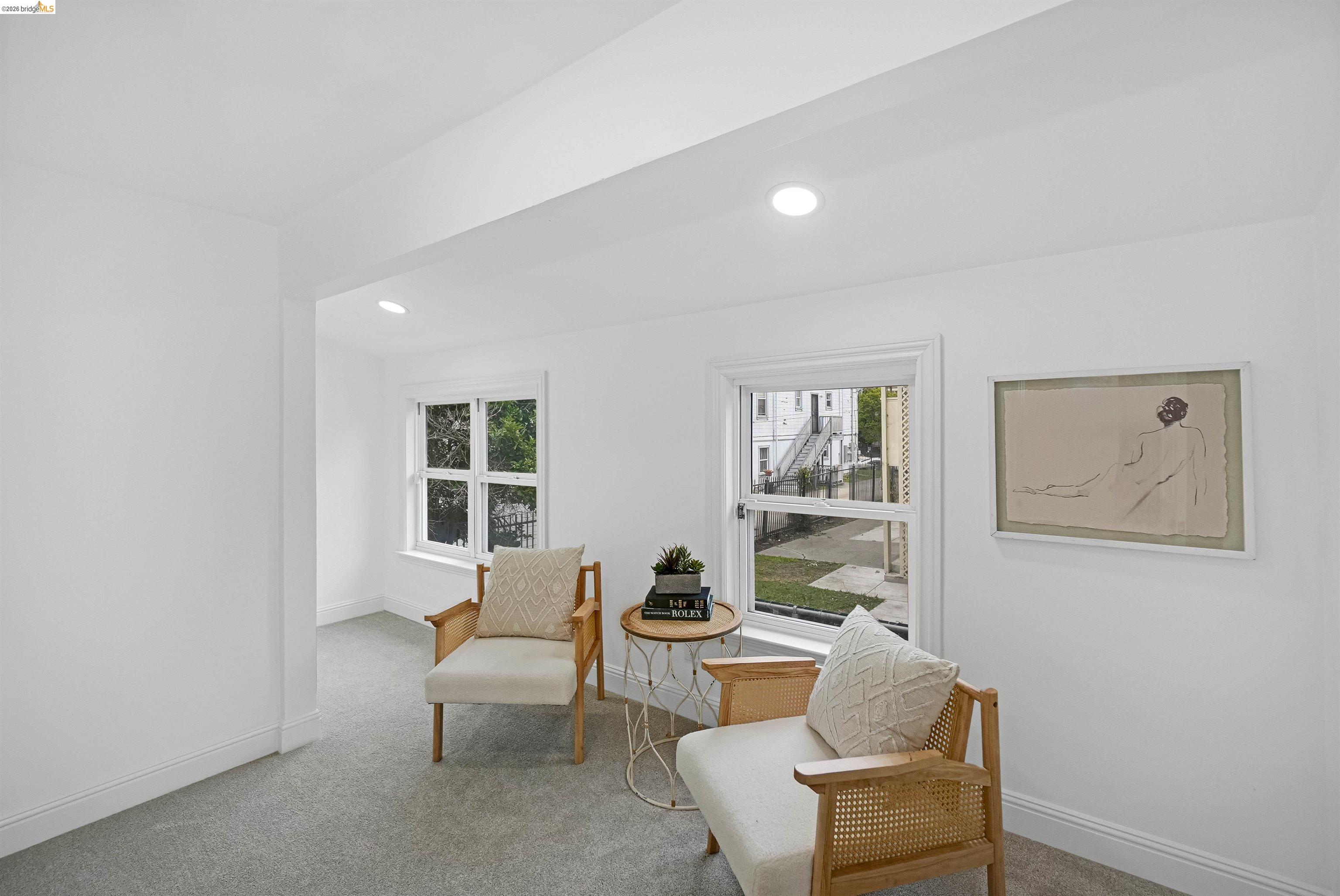 1812 Woolsey Street Berkeley, CA 94703 - Photo 21 of 48 Bright room featuring neutral wall paint, recessed lighting, double-hung windows, and light gray carpeting