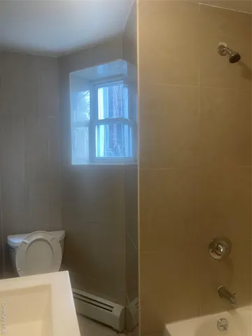 a view of a small space with wooden floor and a window