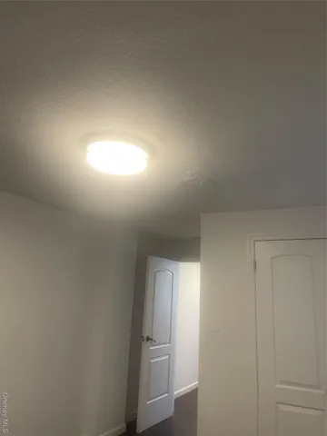 a kitchen with a stove and white cabinets