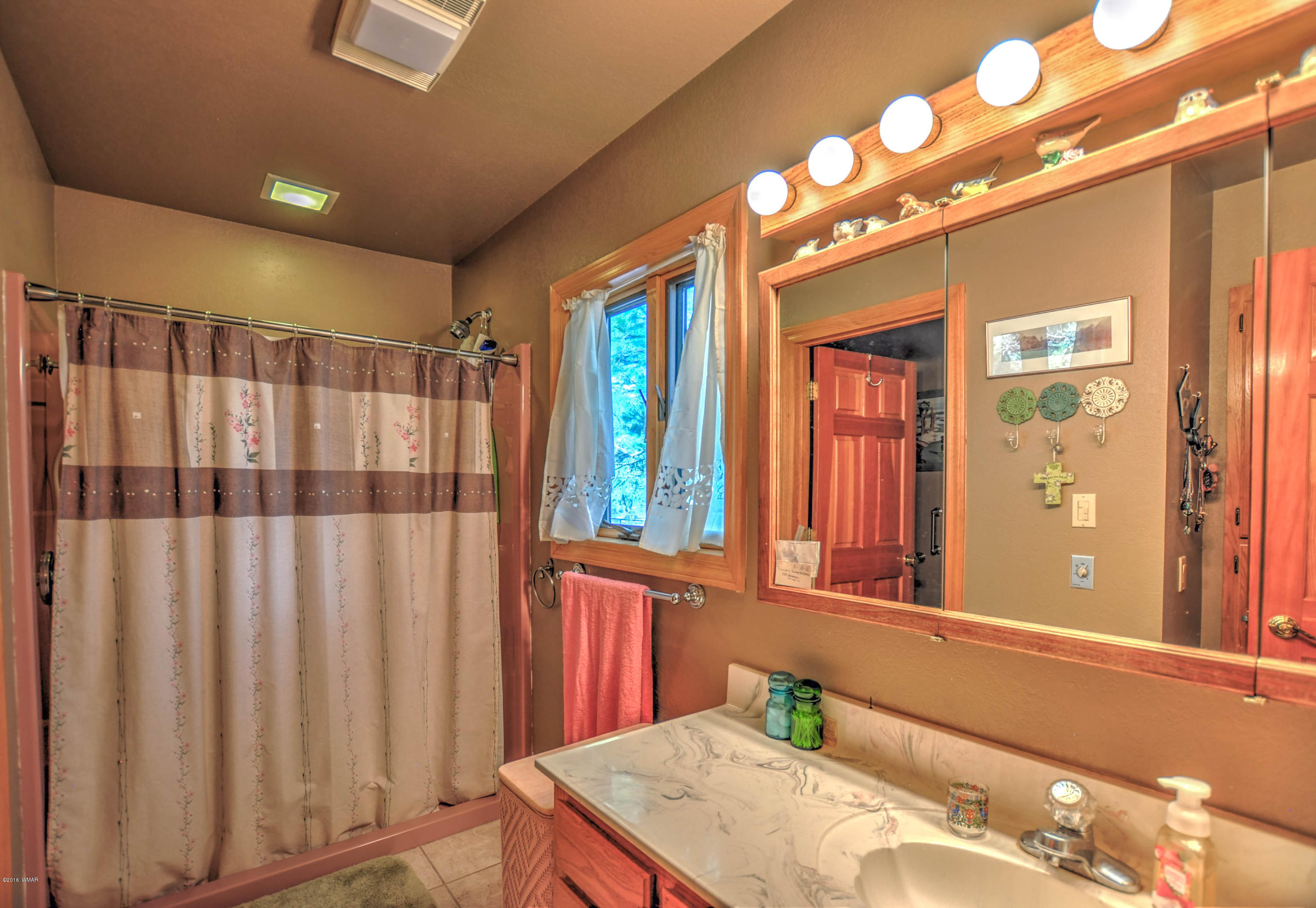2151 Chevelon Road Overgaard, AZ 85933 - Photo 14 of 27 a bathroom with a sink vanity and a mirror