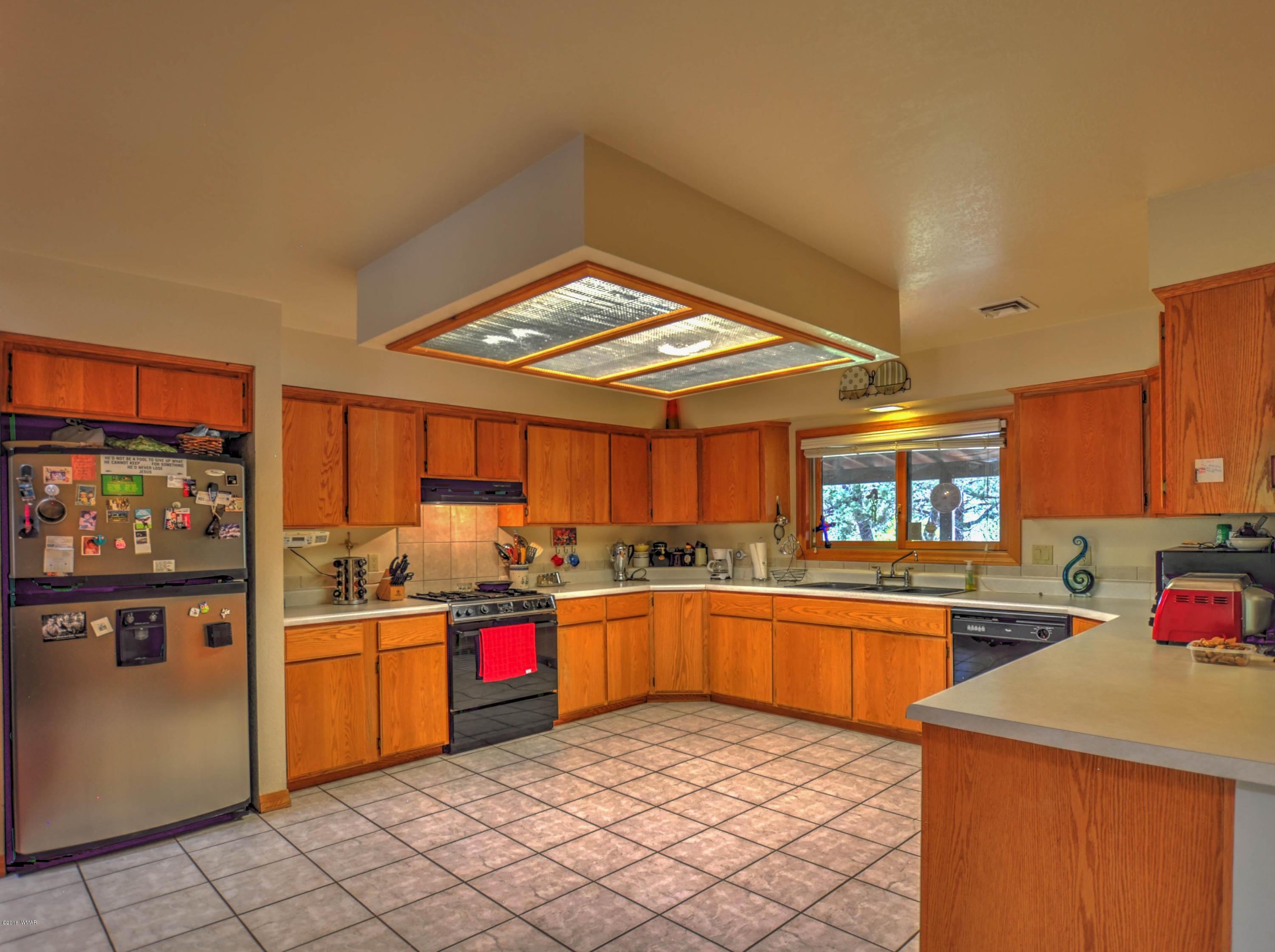 2151 Chevelon Road Overgaard, AZ 85933 - Photo 3 of 27 a kitchen with stainless steel appliances granite countertop a sink and cabinets
