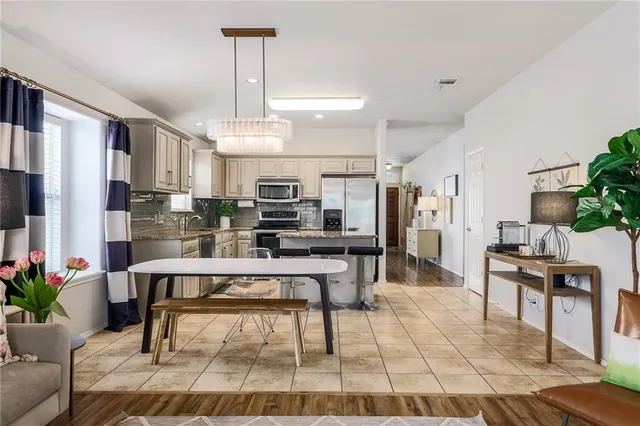 a living room with stainless steel appliances kitchen island granite countertop furniture and a kitchen view