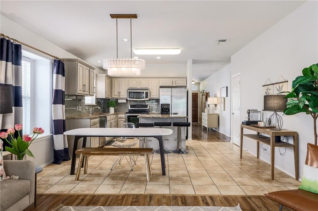 1908 Golden Arrow Avenue Cedar Park, TX 78613 - Photo 12 of 31 a living room with stainless steel appliances kitchen island granite countertop furniture and a kitchen view
