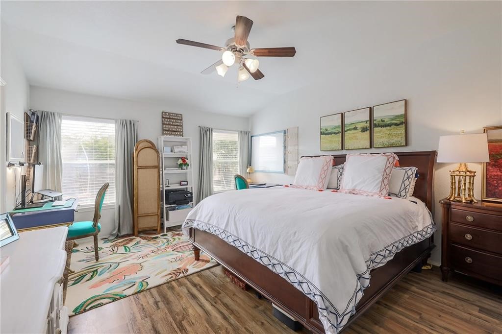 1908 Golden Arrow Avenue Cedar Park, TX 78613 - Photo 15 of 31 a spacious bedroom with a bed a chandelier and large mirror