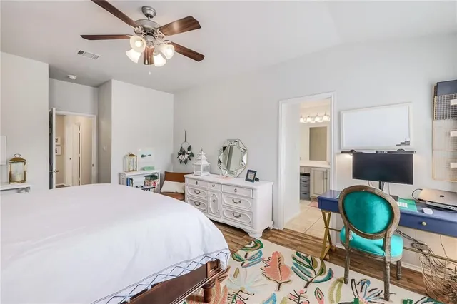 a bedroom with a bed and dresser with mirror