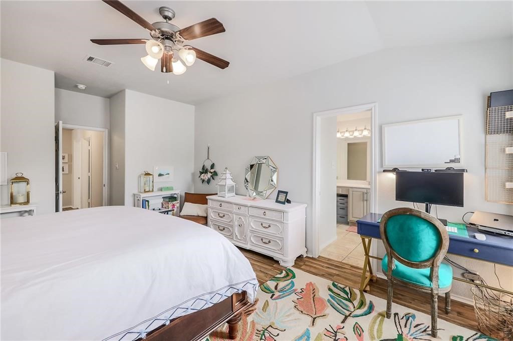 1908 Golden Arrow Avenue Cedar Park, TX 78613 - Photo 16 of 31 a bedroom with a bed and dresser with mirror