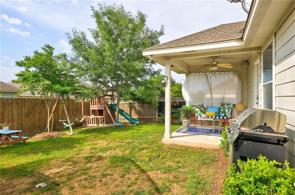 1908 Golden Arrow Avenue Cedar Park, TX 78613 - Photo 24 of 31 a view of a backyard with table and chairs and potted plants