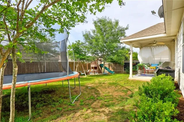 a view of a backyard with a slide