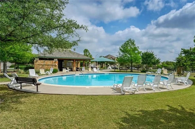 a view of a swimming pool with a patio