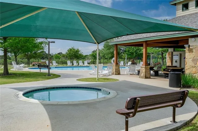 a view of a swimming pool with a patio