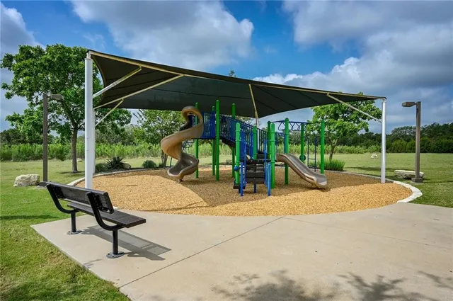 a view of backyard with swimming pool and table