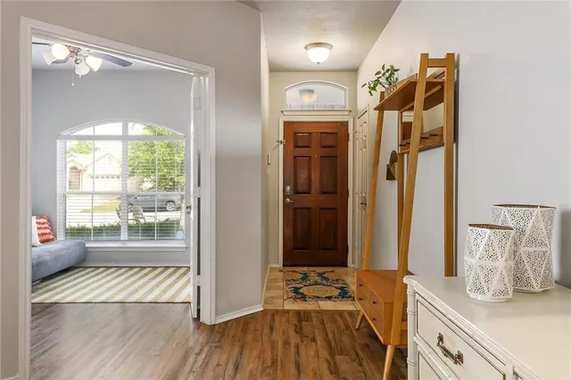 a view of a walk in closet with wooden floor