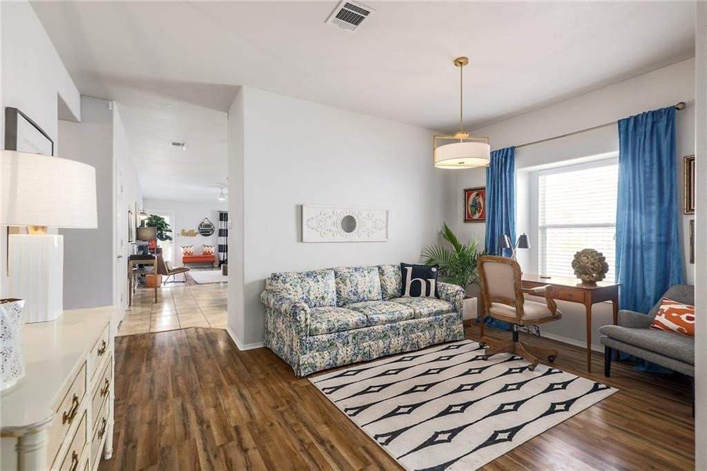1908 Golden Arrow Avenue Cedar Park, TX 78613 - Photo 7 of 31 a living room with furniture and a chandelier