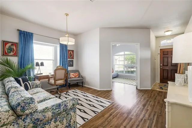 a living room with furniture or wooden floor and a chandelier