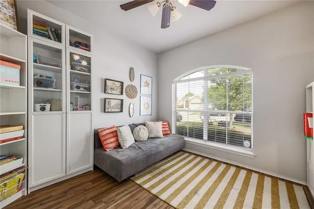 a living room with furniture and a floor to ceiling window