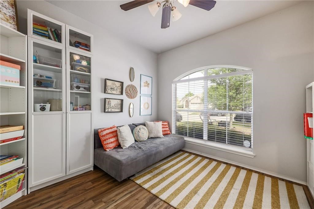 1908 Golden Arrow Avenue Cedar Park, TX 78613 - Photo 9 of 31 a living room with furniture and a floor to ceiling window