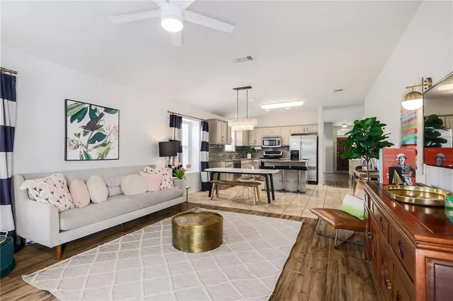 a living room with furniture and view of kitchen