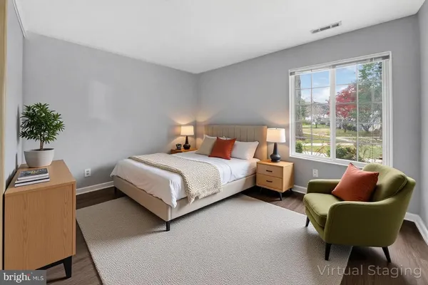 a bedroom with a bed and a chair