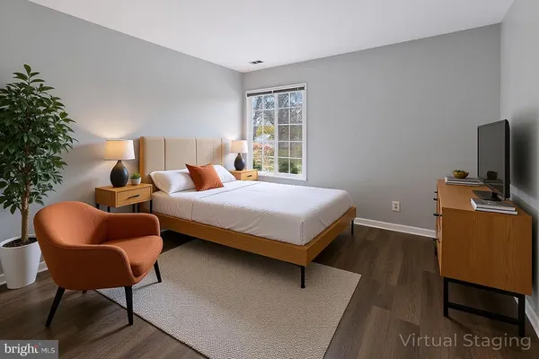 a bedroom with a bed and a couch