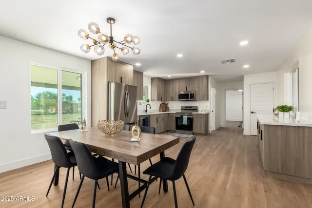 a kitchen with a refrigerator sink and wooden cabinets