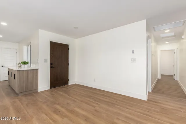 a living room with furniture a fireplace and a large window