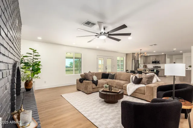 a living room with furniture and a ceiling fan