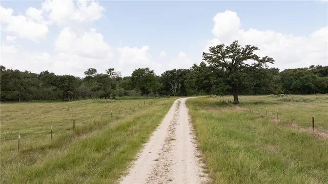 a view of a lake with beach and outdoor space
