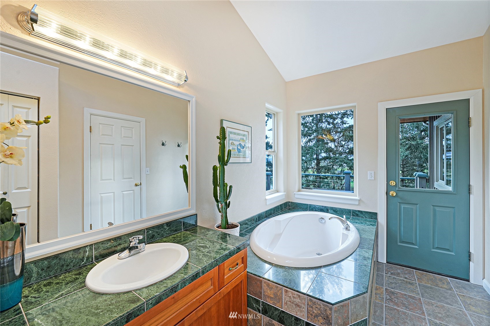 19695 Landing Road Mount Vernon, WA 98273 - Photo 18 of 40 a bathroom with a granite countertop sink and a mirror