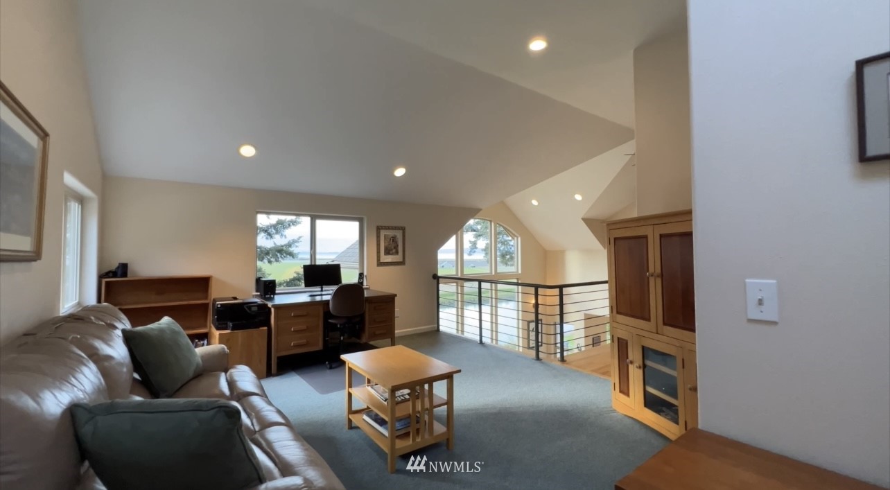 19695 Landing Road Mount Vernon, WA 98273 - Photo 23 of 40 a living room with furniture a fireplace and a large window