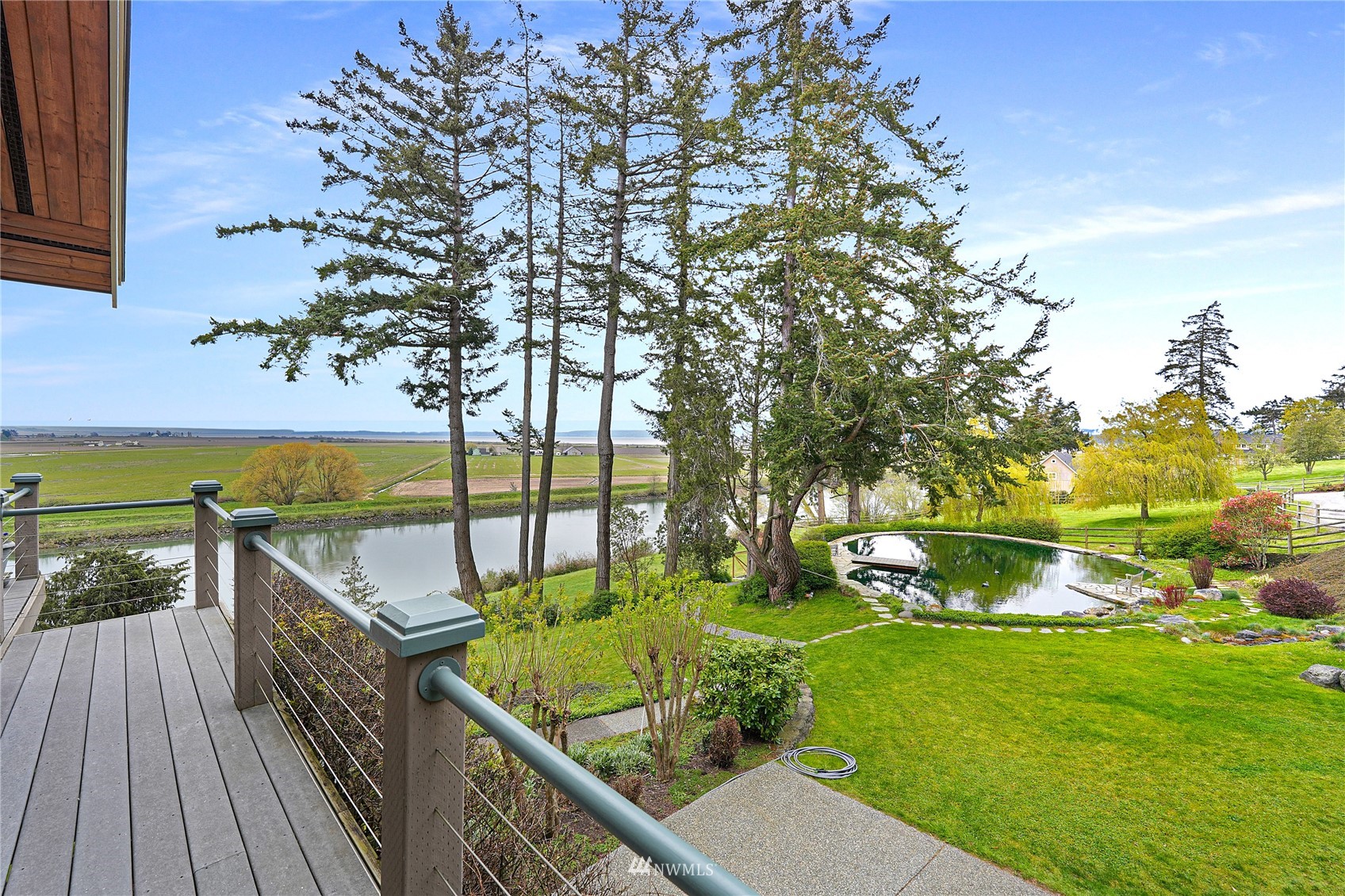 19695 Landing Road Mount Vernon, WA 98273 - Photo 6 of 40 a balcony with wooden floor and lake view