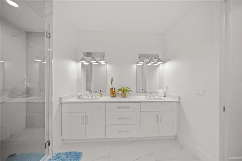 a spacious bathroom with a toilet sink and mirror