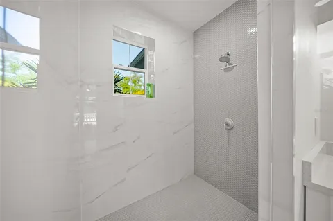 a bathroom with a granite countertop sink a toilet and shower